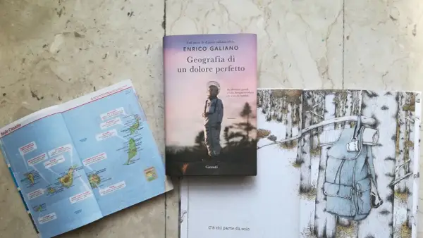 Mappa delle Canarie, libro "Geografia di un dolore perfetto" e illustrazione di uno zaino in un bosco innevato.